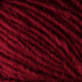 Close-up image of Halcyon Geo Rug Wool by Caledonian Dye Works, showcasing its thick, soft, and slightly fuzzy texture. The dark red strands are tightly twisted together, creating a rich, deep hue with subtle variations in color—perfect for crafting with this premium rug yarn.