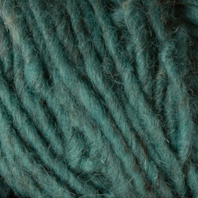 Close-up of green Halcyon Geo Rug Wool fibers from Caledonian Dye Works showing a textured and intertwined pattern. The yarn has a soft and slightly fuzzy appearance, with varying shades of green creating depth and detail in the fibers.