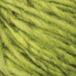 Close-up view of lime green-colored Halcyon Geo Rug Wool by Caledonian Dye Works, showcasing its soft and fluffy texture with intricate fibers and twisted strands. The vibrant color and texture are clearly visible, suggesting it could be used for knitting or crafting projects.