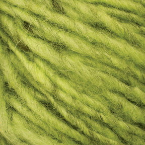 Close-up view of lime green-colored Halcyon Geo Rug Wool by Caledonian Dye Works, showcasing its soft and fluffy texture with intricate fibers and twisted strands. The vibrant color and texture are clearly visible, suggesting it could be used for knitting or crafting projects.