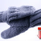 The Soldier's Glomitt from Halcyon Yarn, a pair of gray knit mittens with a foldover mitten flap, is displayed on a white background. In the lower right corner, there is a red and gray Adobe PDF file icon with a downward arrow indicating a download.