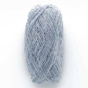 A skein of light blue Einband Lopi wool yarn from Berroco, Inc. is displayed against a plain white background. The yarn is neatly wound in an oval shape, showcasing its soft and slightly fibrous texture, ideal for delicate lace knitting projects.