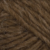 Close-up image of thick, brown Lopi Alafoss Icelandic Wool Yarn by Berroco, Inc. The strands are tightly wound together with some loose fibers visible on the surface, giving it a slightly fuzzy texture perfect for crafting Icelandic pullovers or felted mittens.