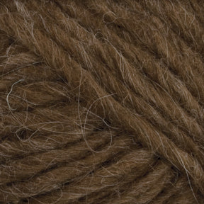 Close-up image of thick, brown Lopi Alafoss Icelandic Wool Yarn by Berroco, Inc. The strands are tightly wound together with some loose fibers visible on the surface, giving it a slightly fuzzy texture perfect for crafting Icelandic pullovers or felted mittens.