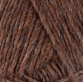 Close-up image of Lopi Alafoss Icelandic Wool Yarn by Berroco, Inc., showcasing brown yarn with mixed shades that reveal the textures of intertwined fibers. The thick, slightly rugged appearance includes hints of light and dark brown interwoven strands, making it perfect for crafting Icelandic pullovers.