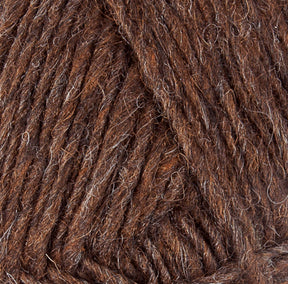 Close-up image of Lopi Alafoss Icelandic Wool Yarn by Berroco, Inc., showcasing brown yarn with mixed shades that reveal the textures of intertwined fibers. The thick, slightly rugged appearance includes hints of light and dark brown interwoven strands, making it perfect for crafting Icelandic pullovers.