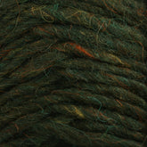 Close-up of a textured, dark green Lopi Alafoss Icelandic Wool Yarn by Berroco, Inc., featuring subtle strands of orange and yellow. The fibrous lines are intertwined, creating a wavy, layered pattern reminiscent of felted mittens.