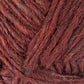 Close-up of a ball of Berroco, Inc.'s Lopi Alafoss Icelandic Wool Yarn in deep burgundy with subtle strands of brown and orange interwoven. The texture is soft, with a slightly irregular and fibrous appearance, showcasing a rich, warm color blend suitable for knitting felted mittens or Icelandic pullovers.