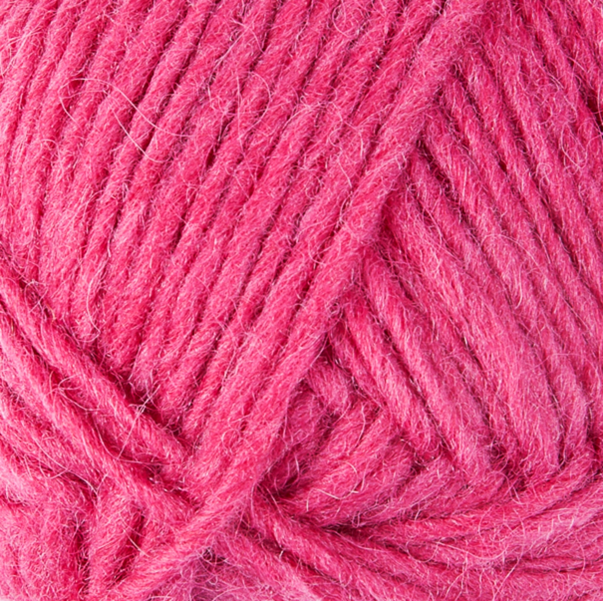 A close-up image of a ball of pink Lopi Alafoss Icelandic Wool Yarn by Berroco, Inc. The yarn fibers are clearly visible, showcasing their soft and textured appearance. The strands are wound neatly and tightly into a compact bundle, ideal for crafting Icelandic pullovers or felted mittens.