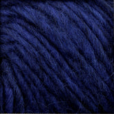 Close-up of the Lopi Alafoss Icelandic Wool Yarn by Berroco, Inc., showcasing its deep blue hue and thick, soft strands. The tightly intertwined fibers create a fuzzy texture, reminiscent of traditional Icelandic pullovers, evoking a sense of warmth and coziness.