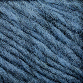 Close-up of blue-gray yarn fibers intertwined, reminiscent of Lopi Alafoss Icelandic Wool Yarn by Berroco, Inc. The texture is soft and slightly fuzzy, showcasing individual threads and strands woven together in a loose, thick pattern.