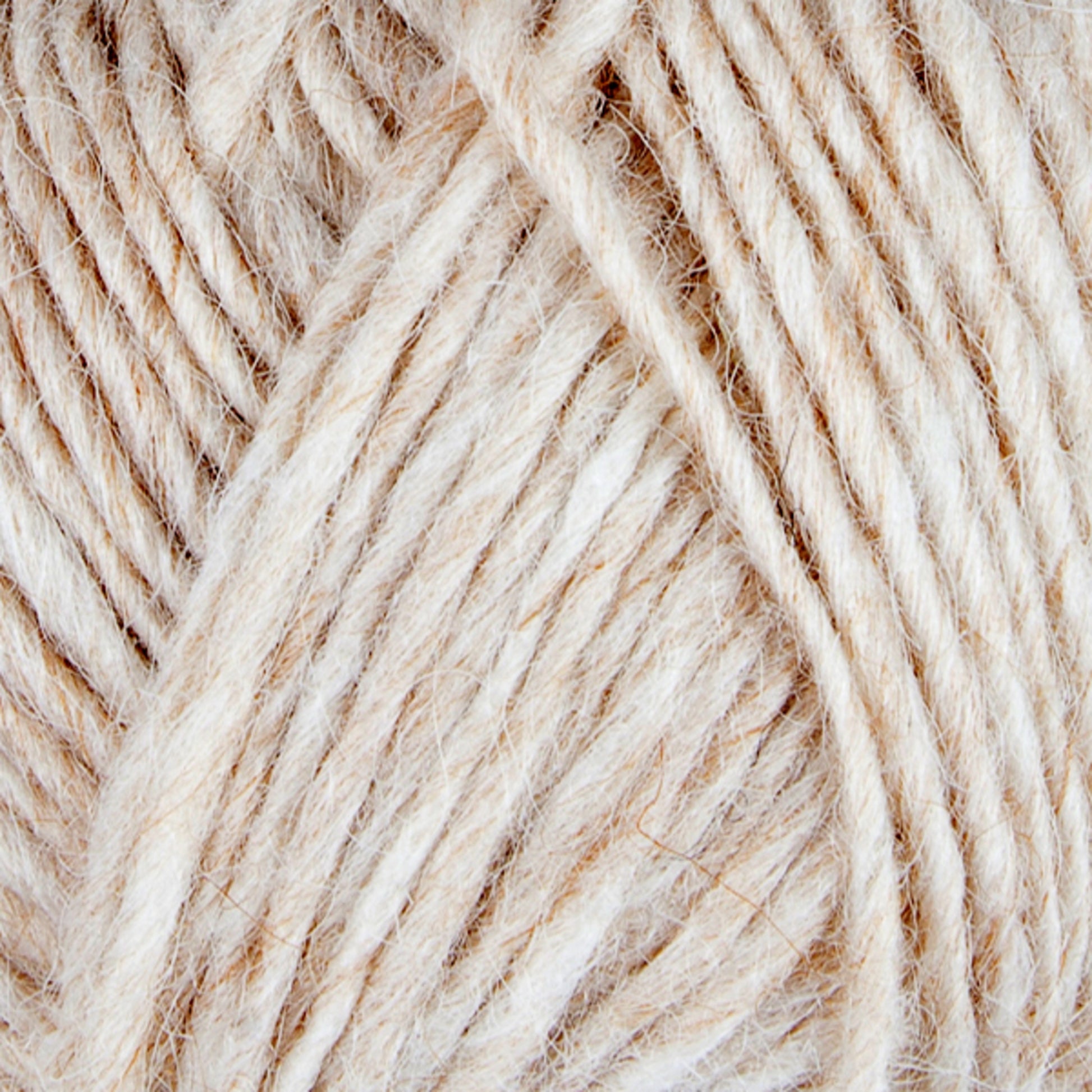 Close-up image of Berroco, Inc.'s Lopi Alafoss Icelandic Wool Yarn in beige and white hues wound into a skein. The thick, textured fibers intertwine, showcasing a soft and fuzzy appearance, ideal for knitting Icelandic pullovers or crocheting projects. The natural hues reflect a neutral, earthy tone.