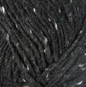 Close-up of dark grey Lopi Alafoss Icelandic Wool Yarn by Berroco, Inc., with a textured appearance featuring subtle white flecks throughout its fibers. The yarn is tightly wound, showcasing its soft and slightly fuzzy surface, perfect for crafting Icelandic pullovers.