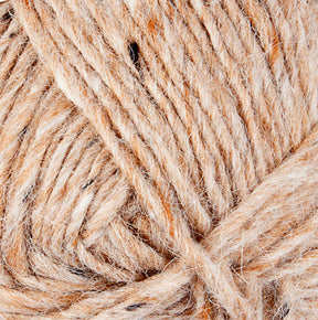 Close-up view of a skein of Lopi Alafoss Icelandic Wool Yarn by Berroco, Inc. The yarn is a mix of beige and white fibers, creating a textured pattern. The fibers appear soft and slightly fuzzy, with a twisted strand formation typical of spun yarn perfect for crafting Icelandic pullovers.