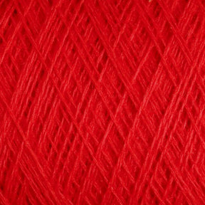 A close-up view of the vibrant red JaggerSpun Maine Line 3/8 Yarn on a large cone by Jagger Brothers, Inc. The texture is visible, showing intricate, crisscrossing threads of worsted spun yarns tightly wound together. The image highlights the rich color and the fine details of the soft medium-grade wool fibers.
