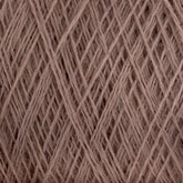 A close-up image of taupe-colored JaggerSpun Maine Line 3/8 Yarn | Mini-cone by Jagger Brothers, Inc. intricately wound in a crisscross pattern. The fibers appear soft and slightly fuzzy, forming a dense network of overlapping strands.