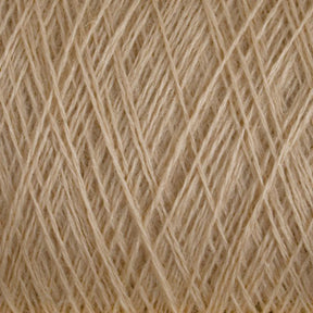 Close-up of a spool of beige JaggerSpun Maine Line 3/8 Yarn | Mini-cone from Jagger Brothers, Inc. The fibers are tightly wound and intricately crisscrossed, forming a textured pattern. The individual threads have a slightly fuzzy appearance, indicating a soft and delicate material, characteristic of Maine wool yarns.