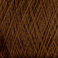 Close-up of brown Jagger Brothers, Inc. JaggerSpun Maine Line 3/8 Yarn Mini-cone, tightly wound together, showcasing a textured surface with intersecting threads. The image highlights the detailed and intricate pattern formed by the overlapping fibers. The overall appearance is soft and fibrous.