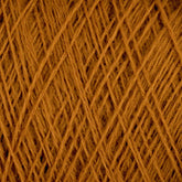 Close-up image of JaggerSpun Maine Line 3/8 Yarn | Mini-cone from Jagger Brothers, Inc., wrapped in a crisscross pattern. The texture appears soft and fibrous, with visible individual strands forming a dense, intricate network, showcasing the quality of worsted spun yarns.