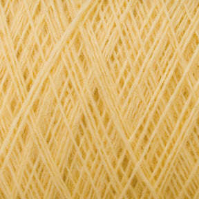 Close-up image of JaggerSpun Maine Line 3/8 Yarn from Jagger Brothers, Inc., showcasing yellow worsted spun yarn strands intricately woven together to form a textured pattern. The yarn appears soft and slightly fluffy, with a warm, sunny hue. The image captures the details of the individual fibers and the overall structure of the weave.