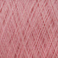 Close-up view of a spool of pink JaggerSpun Maine Line 3/8 Yarn on a large cone by Jagger Brothers, Inc. The fibers are finely woven together, creating a dense and textured look. Made from soft medium grade wool, the yarn appears perfect for knitting or crocheting projects. The pink color is even and consistent throughout.