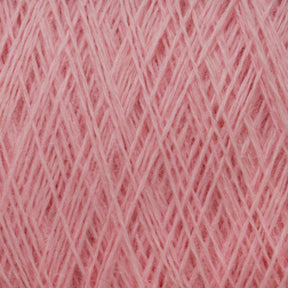 Close-up view of a spool of pink JaggerSpun Maine Line 3/8 Yarn on a large cone by Jagger Brothers, Inc. The fibers are finely woven together, creating a dense and textured look. Made from soft medium grade wool, the yarn appears perfect for knitting or crocheting projects. The pink color is even and consistent throughout.