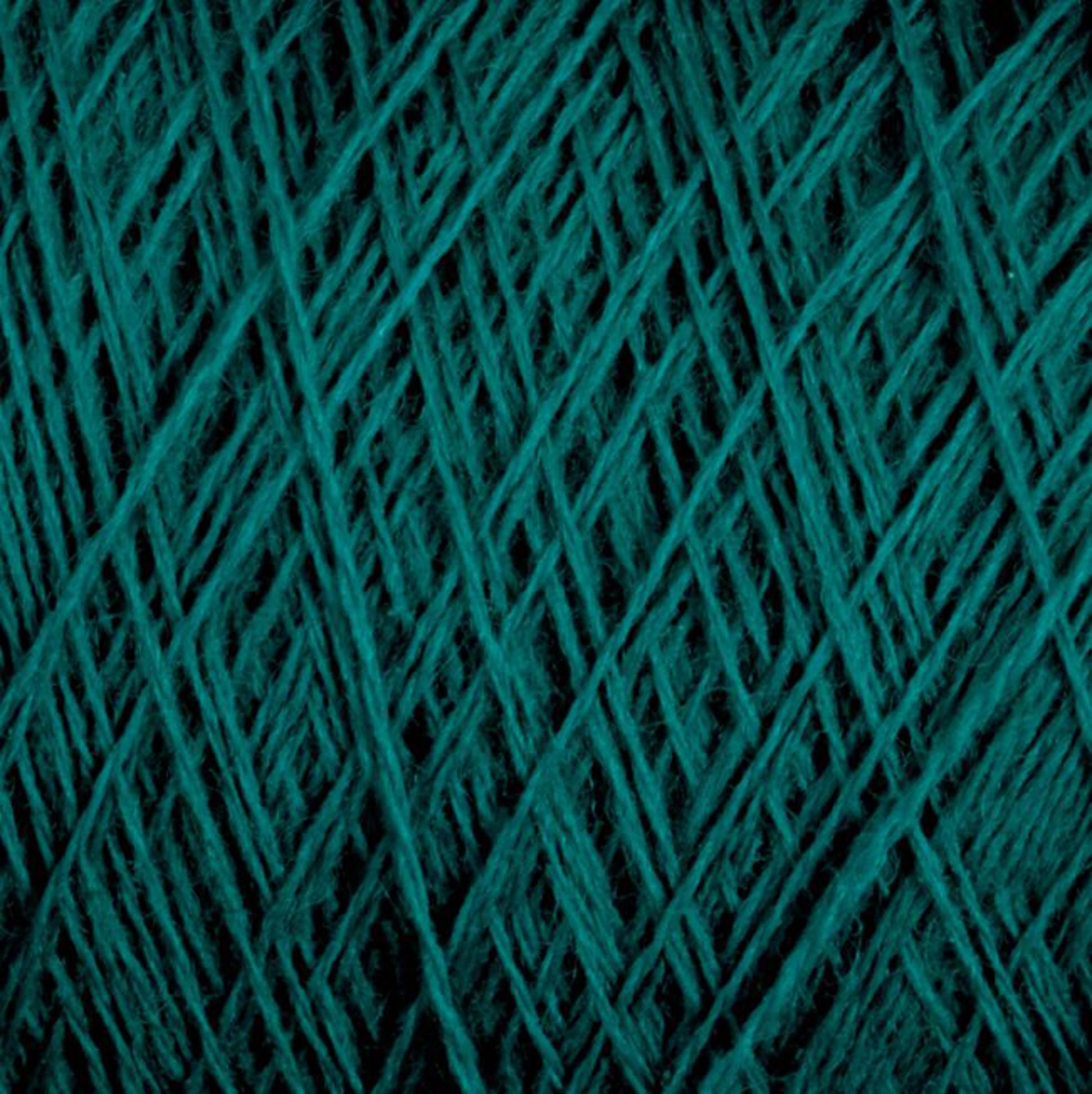 A close-up image of tightly wound, thick JaggerSpun Maine Line 3/8 Yarn from Jagger Brothers, Inc. showcases its fuzzy texture. The yarn, arranged in an overlapping crisscross pattern reminiscent of traditional Maine wool yarns, creates a dense and intricate visual effect. The rich teal color enhances its vibrant appearance.