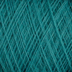 Close-up image of teal-colored JaggerSpun Maine Line 3/8 Yarn | Mini-cone by Jagger Brothers, Inc. These yarns are densely woven, creating a textured pattern of crisscrossed fibers. The overall appearance is soft and intricate, with varying shades of teal adding depth to the texture.