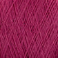 Close-up image of a spool of pink JaggerSpun Maine Line 3/8 Yarn | Mini-cone by Jagger Brothers, Inc. The worsted spun yarn is tightly wound, with visible fibers creating a textured pattern of crisscrossing threads.