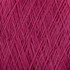 Close-up image of a spool of pink JaggerSpun Maine Line 3/8 Yarn | Mini-cone by Jagger Brothers, Inc. The worsted spun yarn is tightly wound, with visible fibers creating a textured pattern of crisscrossing threads.