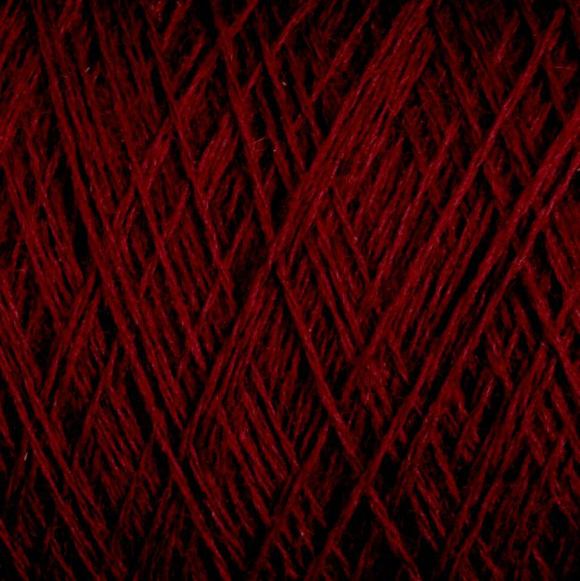 Close-up image of JaggerSpun Maine Line 3/8 Yarn | Mini-cone by Jagger Brothers, Inc., featuring its intricate, interwoven strands. The texture is soft with a deep, rich red color that fills the entire frame, highlighting the complexity and detail of the threads.