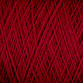 A close-up view of a spool of JaggerSpun Maine Line 3/8 Yarn | Mini-cone by Jagger Brothers, Inc. showcases the rich, red threads tightly wound in crisscross patterns, creating a textured surface. The vivid red color is evenly distributed throughout the worsted spun yarns.