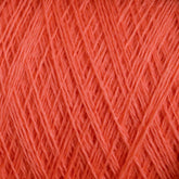 Close-up image of coral-colored JaggerSpun Maine Line 3/8 Yarn from Jagger Brothers, Inc. The tightly wound strands create a textured pattern across the frame, highlighting the yarn's smooth and fine appearance, typical of this soft medium grade wool.