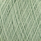 Close-up view of the JaggerSpun Maine Line 3/8 Yarn from Jagger Brothers, Inc., in a soft, light green color, tightly wound in a crisscross pattern. The yarn’s texture appears fuzzy and delicate, ideal for knitting or crocheting projects. This JaggerSpun yarn showcases the gentle quality of soft medium grade wool.