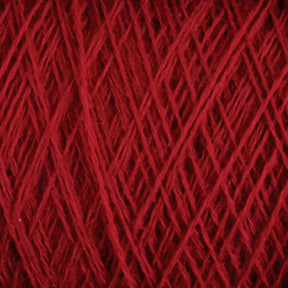 Close-up view of a ball of JaggerSpun Maine Line 2/8 Yarn | Mini-cone by Jagger Brothers, Inc., showcasing the intricate interwoven strands and the soft, fuzzy texture typical of worsted spun yarn. The crisscross pattern highlights the thickness and richness of the red color, reminiscent of fine knitting or weaving.