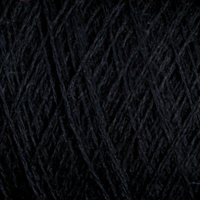 A close-up image of JaggerSpun Maine Line 2/8 Yarn | Mini-cone by Jagger Brothers, Inc. The worsted spun yarn is tightly wound, showcasing its fibrous texture and intricate overlapping strands. The detailed view highlights the thickness and subtle variations in the fiber, making it perfect for weaving or knitting projects.