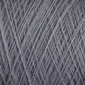 Close-up view of a ball of JaggerSpun Maine Line 2/8 Yarn | Mini-cone by Jagger Brothers, Inc. The individual strands are tightly wound and intertwined, creating a textured surface with visible fibers, perfect for knitting projects.