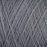 Close-up of a tightly wound ball of JaggerSpun Maine Line 2/8 Yarn from Jagger Brothers, Inc., showcasing the intricate pattern of crisscrossing threads. The texture is fuzzy and the consistent gray color appeals to both commercial and recreational knitters.