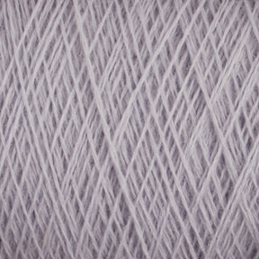 A close-up of the JaggerSpun Maine Line 2/8 Yarn mini-cone by Jagger Brothers, Inc. reveals the intricate crisscrossing pattern of its light gray fibers. The texture appears soft and slightly fuzzy, suggesting a possible wool or wool-blend material. Perfect for knitting, this worsted spun yarn offers a uniform and neat overall appearance.