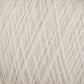 Close-up image of JaggerSpun Maine Line 2/8 Yarn from Jagger Brothers, Inc., wound into a ball. The off-white fingering gauge yarn showcases an intricate, crisscrossed pattern with its individual strands. Its soft and slightly fuzzy texture suggests the use of natural fibers. The neutral tone provides a cozy and versatile appearance, making it ideal for commercial and recreational knitters alike.