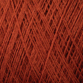 Close-up view of a dense, reddish-brown JaggerSpun Maine Line 2/8 Yarn with tightly interwoven fibers, creating a textured pattern of crisscrossing threads. Manufactured by Jagger Brothers, Inc., the mini-cone showcases an appearance rich in color and detail, highlighting the intricate structure of the yarn that is perfect for knitting.