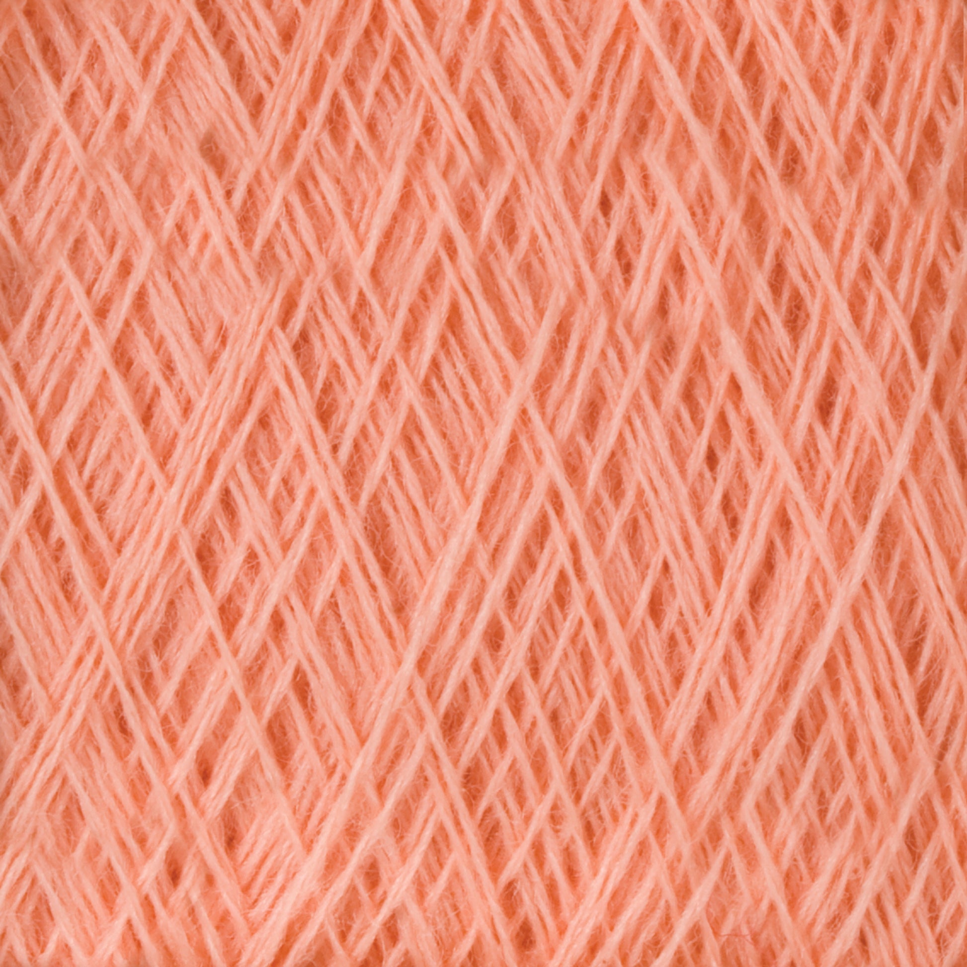 A close-up image of JaggerSpun Maine Line 2/8 Yarn | Mini-cone by Jagger Brothers, Inc. showcases the intricate, crisscrossing strands tightly wound together. The texture appears soft and fuzzy, highlighting the delicate fibers and uniformity of the worsted spun yarn threads, making it perfect for knitting or weaving projects.