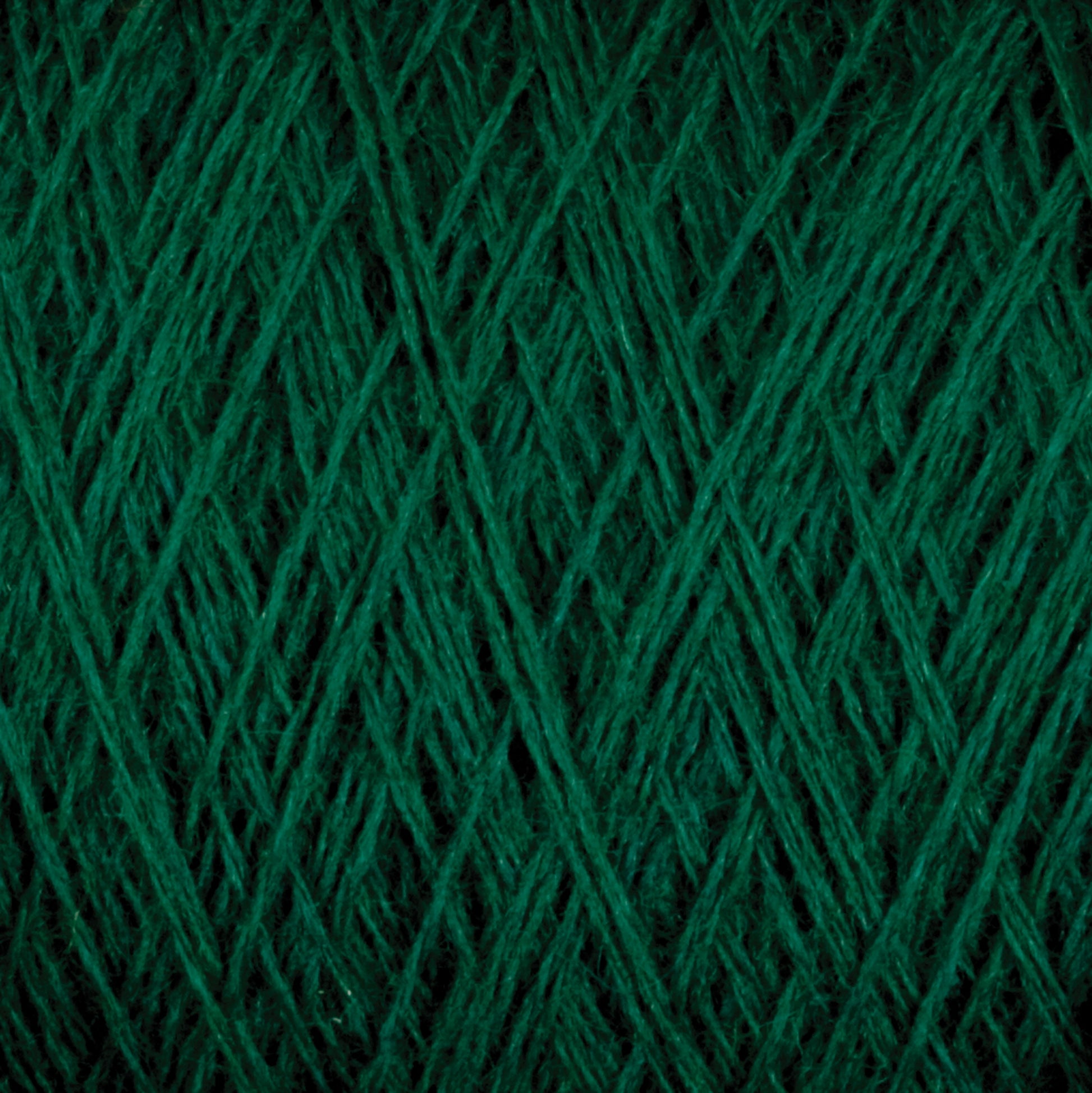 Close-up image of a spool of Jagger Brothers, Inc. JaggerSpun Maine Line 2/8 Yarn | Mini-cone in dark green, showing the detailed texture and interwoven fibers. The tightly wound strands create a pattern of crisscrossing lines and varying shades of green, highlighting the natural fuzziness ideal for knitting or weaving projects.