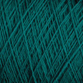 Close-up image of JaggerSpun Maine Line 2/8 Yarn in teal, arranged in a crisscross pattern. The texture appears soft and slightly fluffy, characteristic of worsted spun yarn by Jagger Brothers, Inc., with a rich, deep color that adds a sense of warmth and coziness perfect for knitting projects.