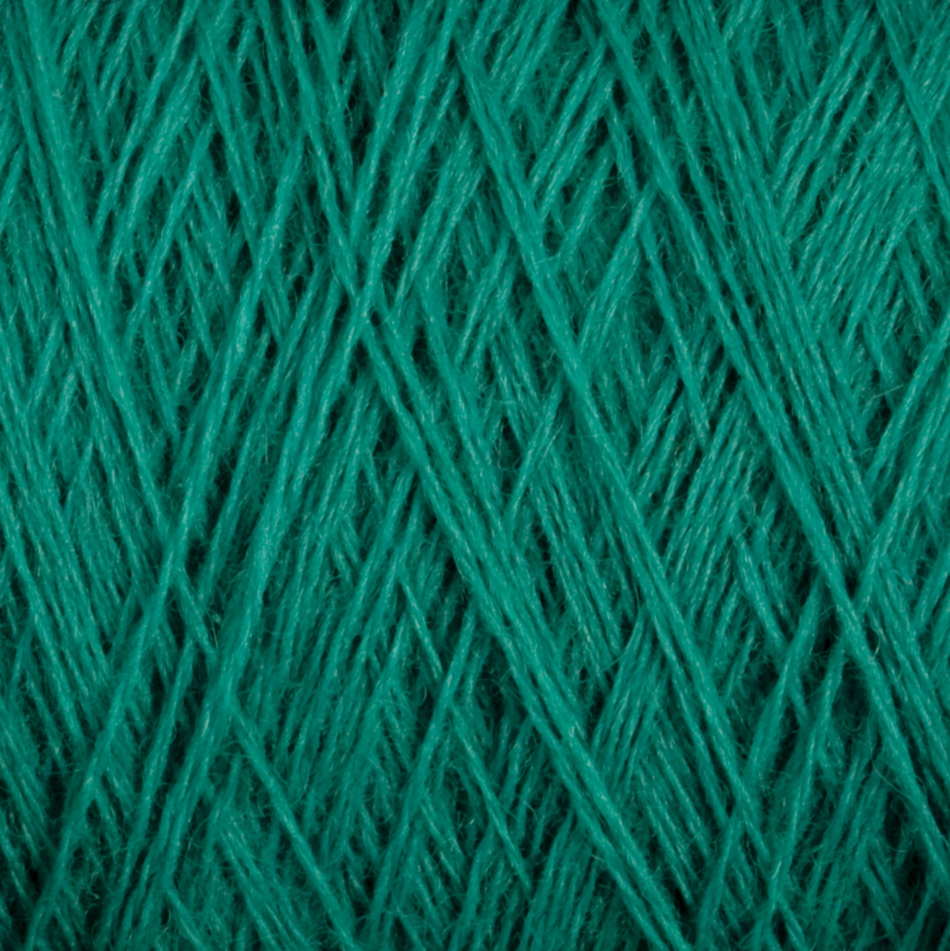 Close-up of a JaggerSpun Maine Line 2/8 Yarn mini-cone from Jagger Brothers, Inc. in a vibrant green, featuring tightly wound fibers that create an intricate crisscross pattern, ideal for knitting. The texture is soft and fuzzy, reflecting the fine details associated with worsted spun yarn.