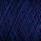 Close-up image of tightly wound, dark blue JaggerSpun Maine Line 2/8 Yarn | Mini-cone from Jagger Brothers, Inc. The texture is detailed, showcasing fibrous threads interwoven in a crisscross pattern, conveying a sense of the material’s softness and density.