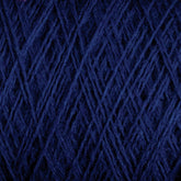 Close-up image of a dark blue yarn ball, showing the detailed texture and interwoven strands. The tightly wound fibers create a complex crisscross pattern, typical of 27.5 micron worsted spun wool yarn, highlighting the soft and fibrous nature of Jagger Brothers' Maine Line 2/8 Yarn in a large cone.