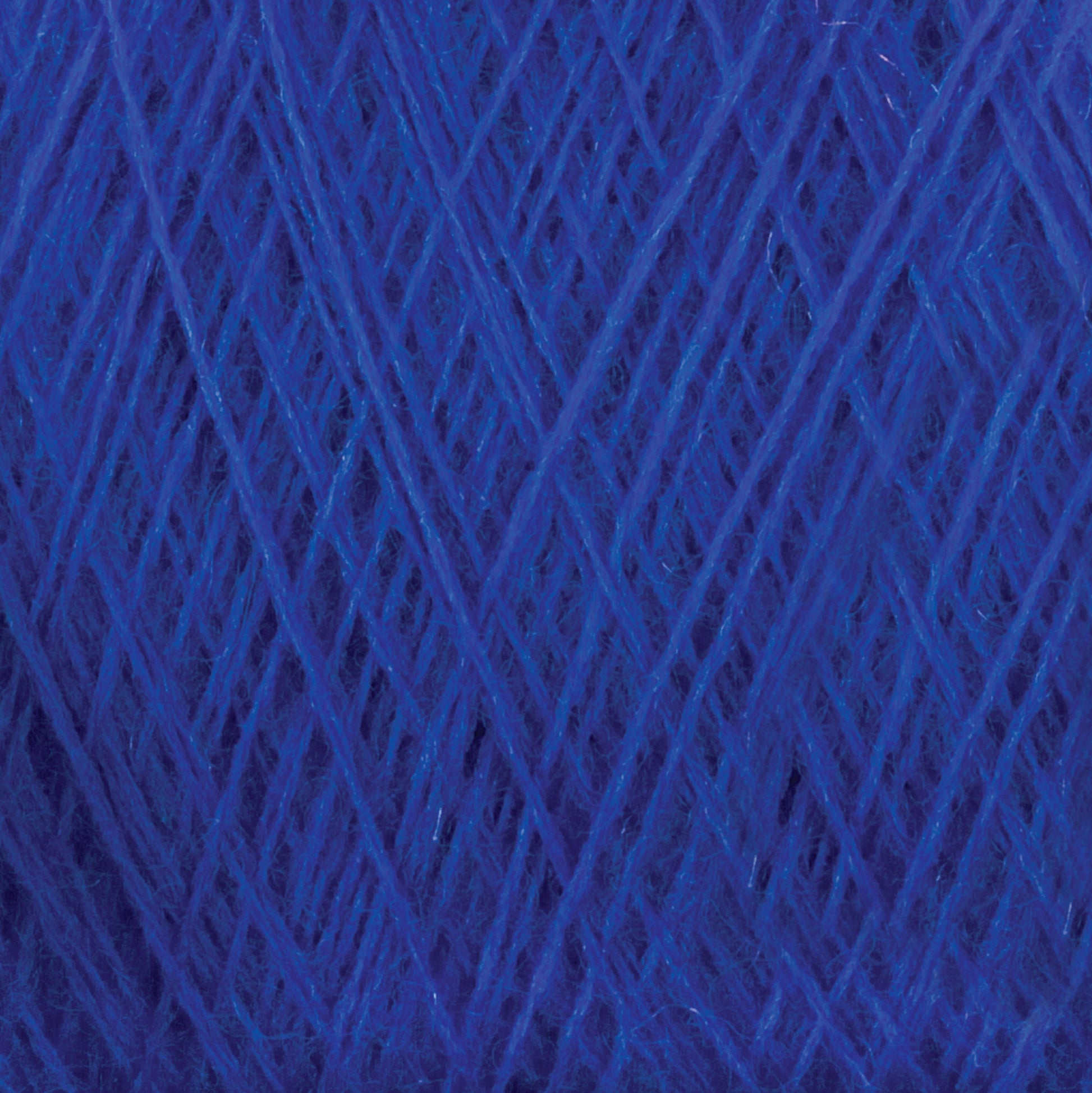 A close-up of Jagger Brothers, Inc.'s JaggerSpun Maine Line 2/8 Yarn in a rich deep blue color, wound in a crisscross pattern. The yarn exhibits a soft and slightly fuzzy texture with fine individual fibers intertwined tightly, capturing the intricate details of the thread.