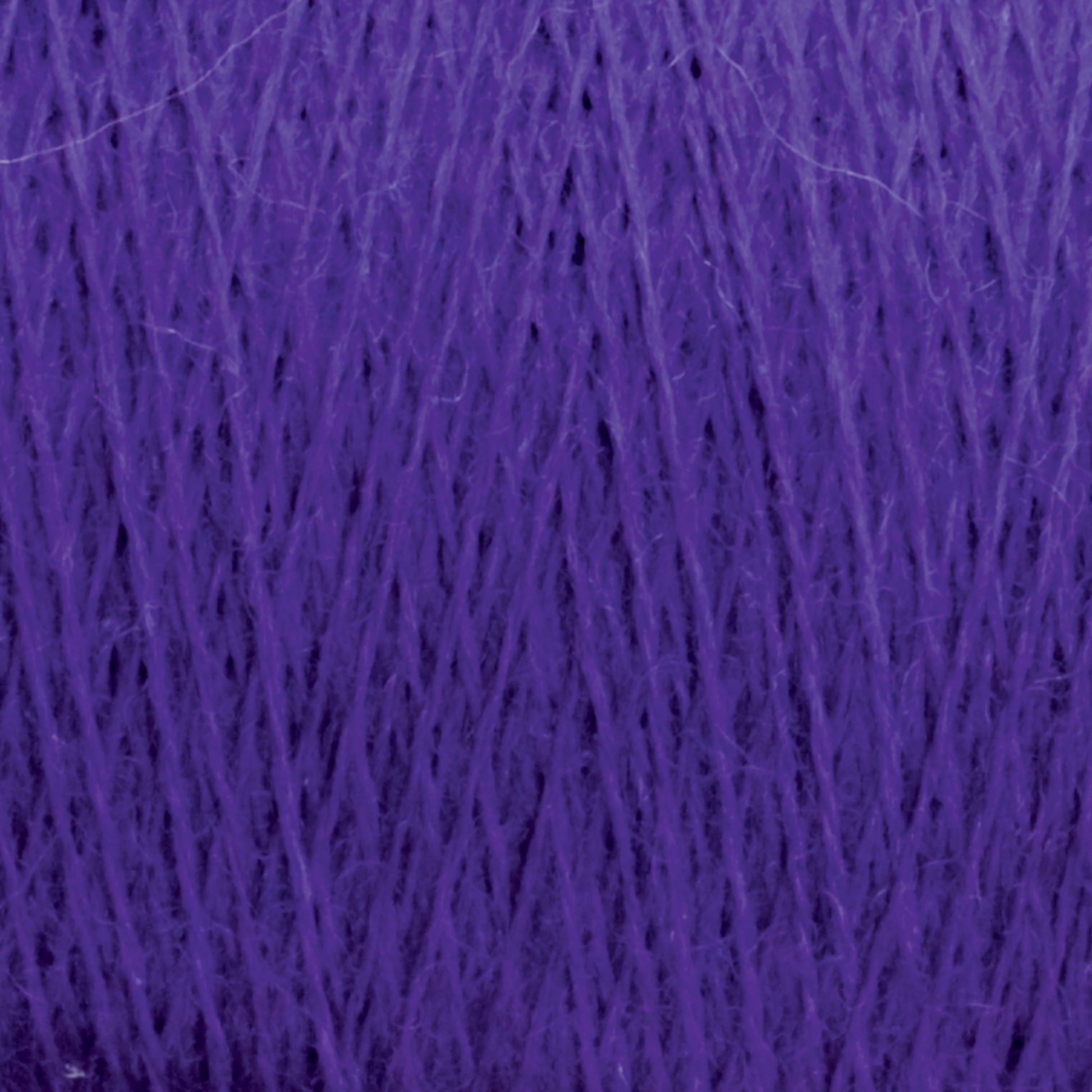 Close-up of JaggerSpun Maine Line 2/8 Yarn | Mini-cone from Jagger Brothers, Inc., showcasing its purple worsted spun composition with a slightly fuzzy texture, tightly wound into a ball. The strands are intricately arranged in an overlapping crisscross pattern, making it ideal for knitting or weaving projects.