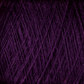 Close-up image of JaggerSpun Maine Line 2/8 Yarn Mini-cone by Jagger Brothers, Inc., showcasing a ball of dark purple, worsted spun yarn. The fibers are tightly wound, with visible strands crisscrossing each other, creating a textured and intricate pattern perfect for knitting or weaving projects.